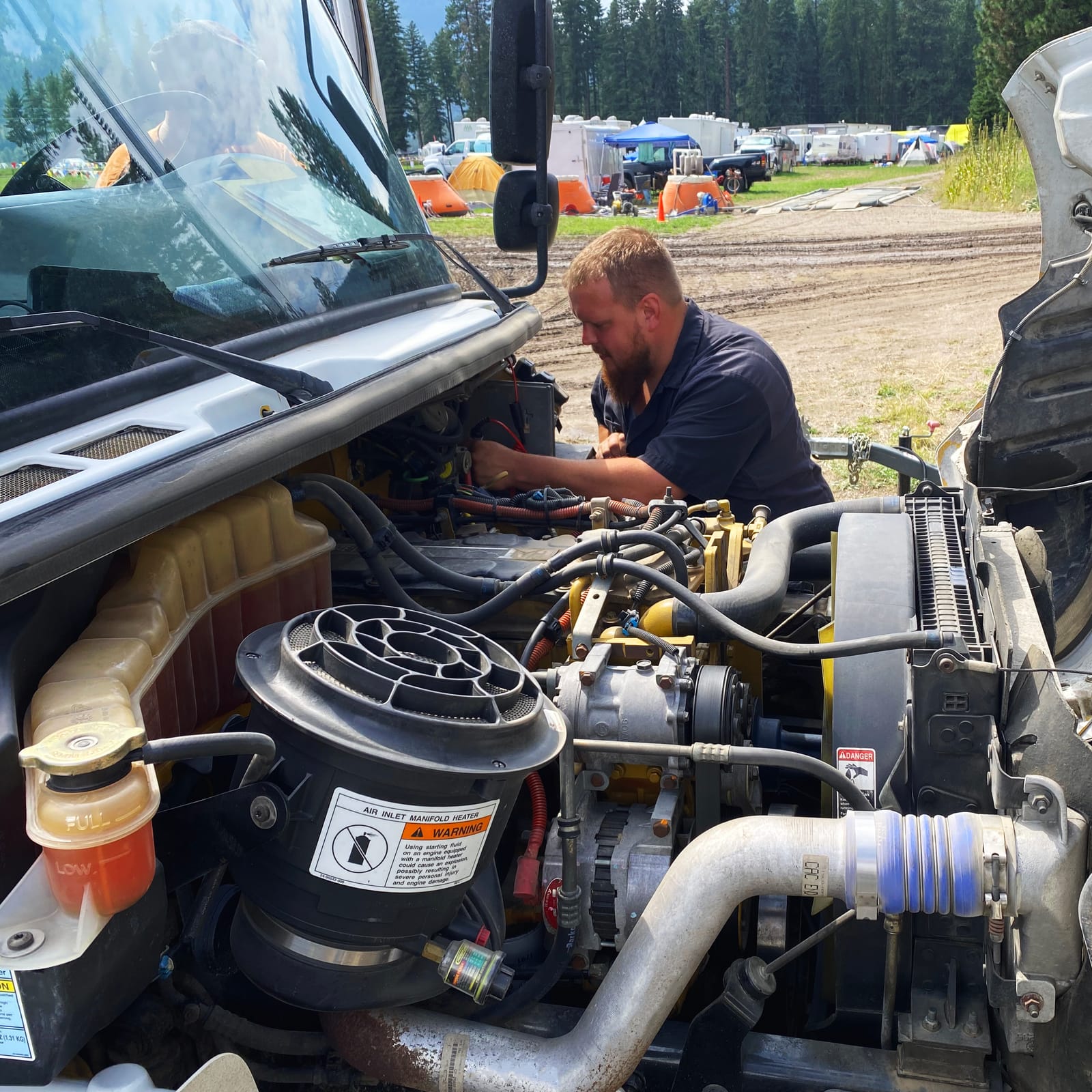 Technician working on truck engine